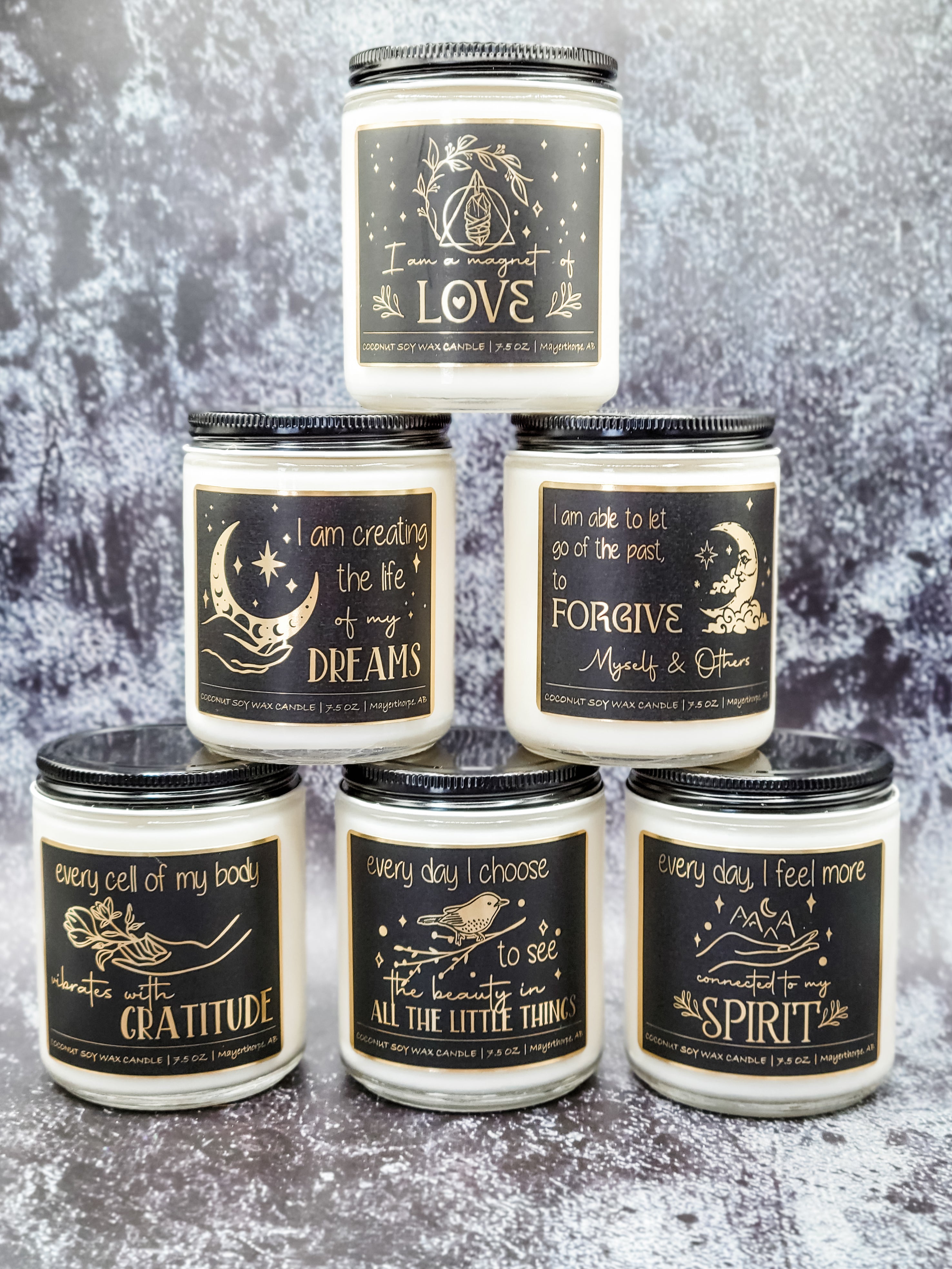 Affirmation candles with gold foil affirmation labels.