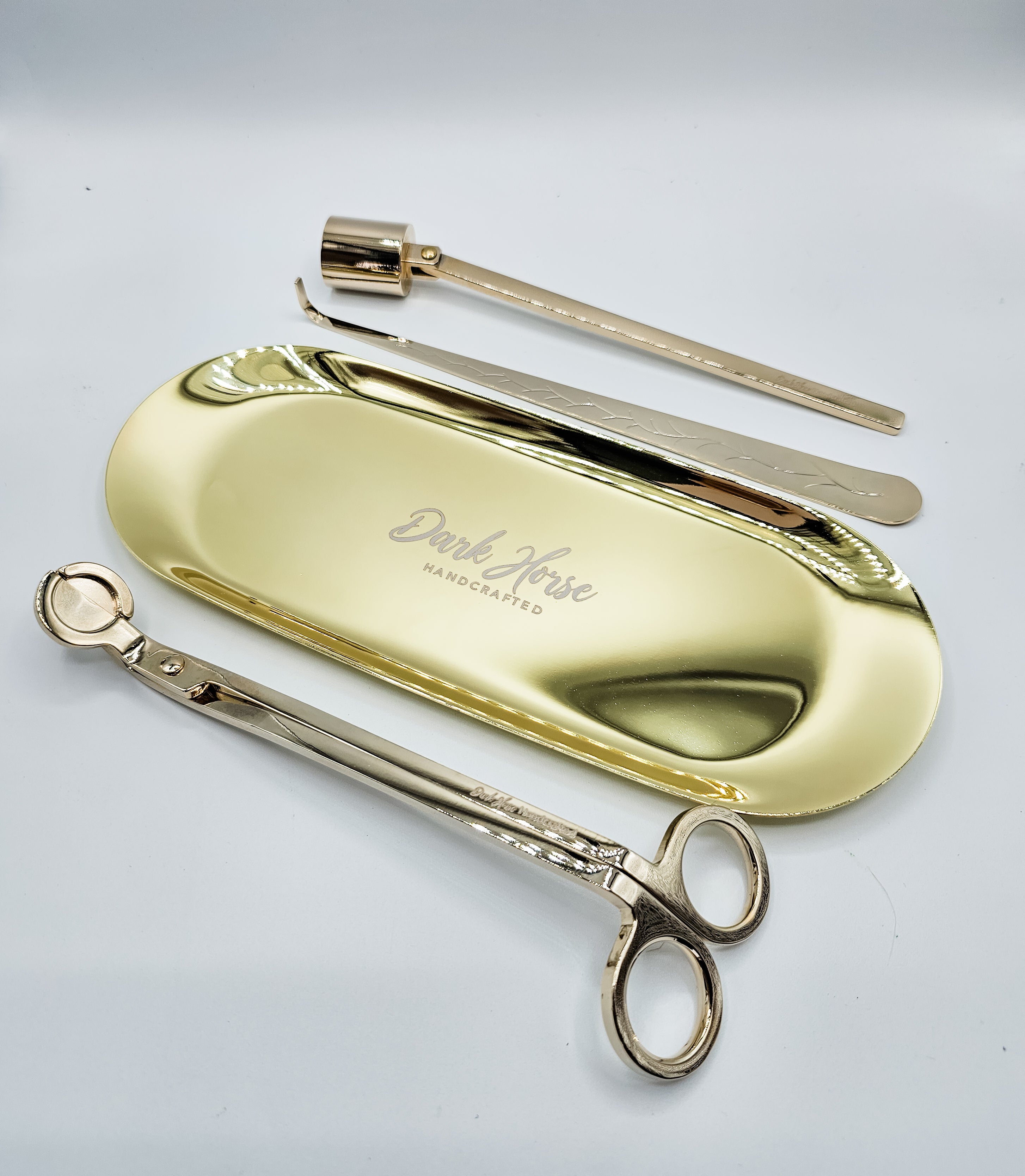 Gold candle accessory kit which includes tray, snuffer, wick dipper & wick trimmer.